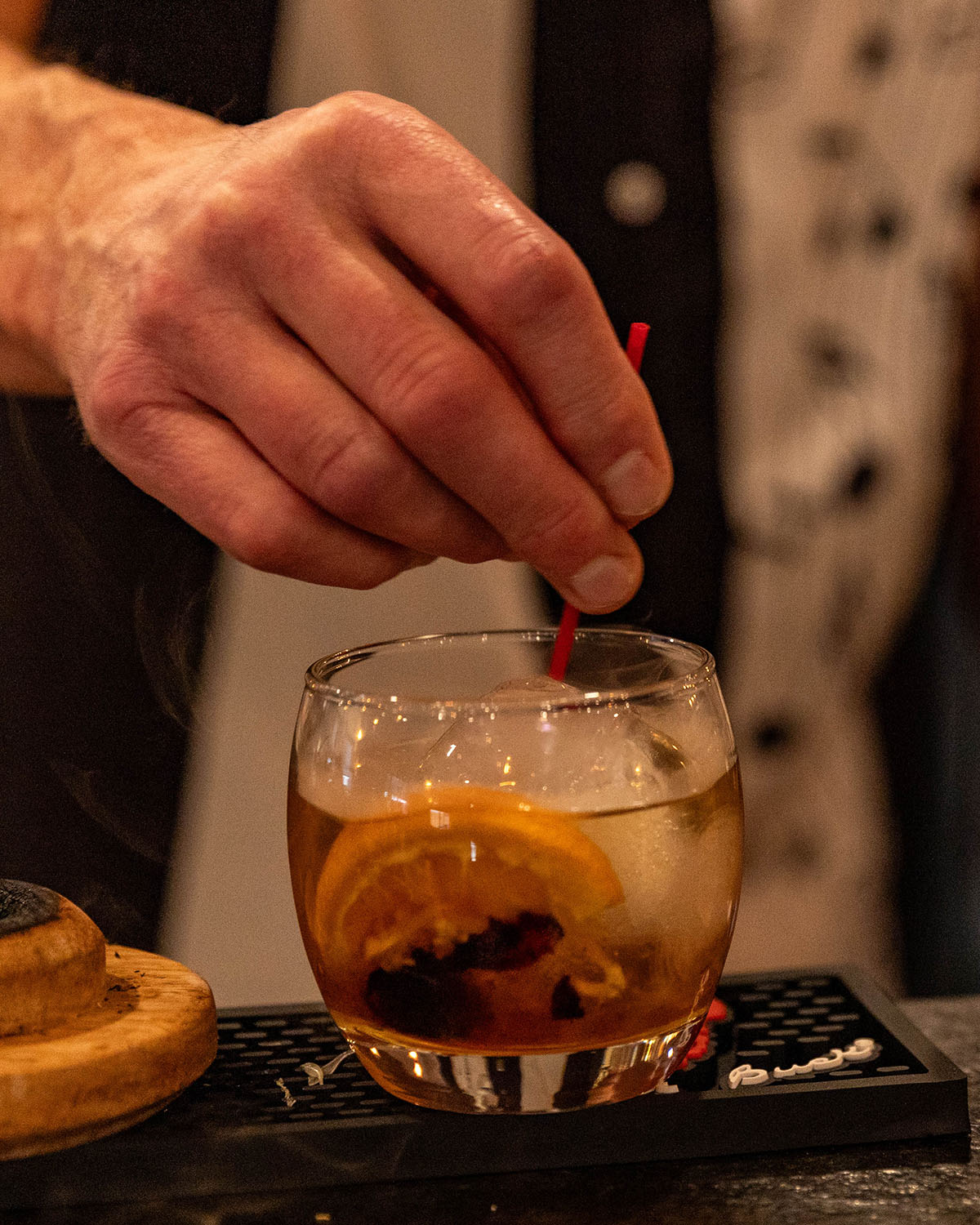 Bartender Finishes the signature 44 old fashioned cocktail